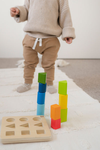 What is gross motor development and what are the key developmental milestones?